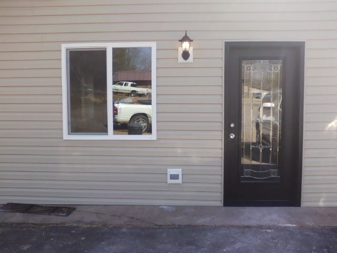 New siding, window and entry door on the side of an addition in Crab Orchard