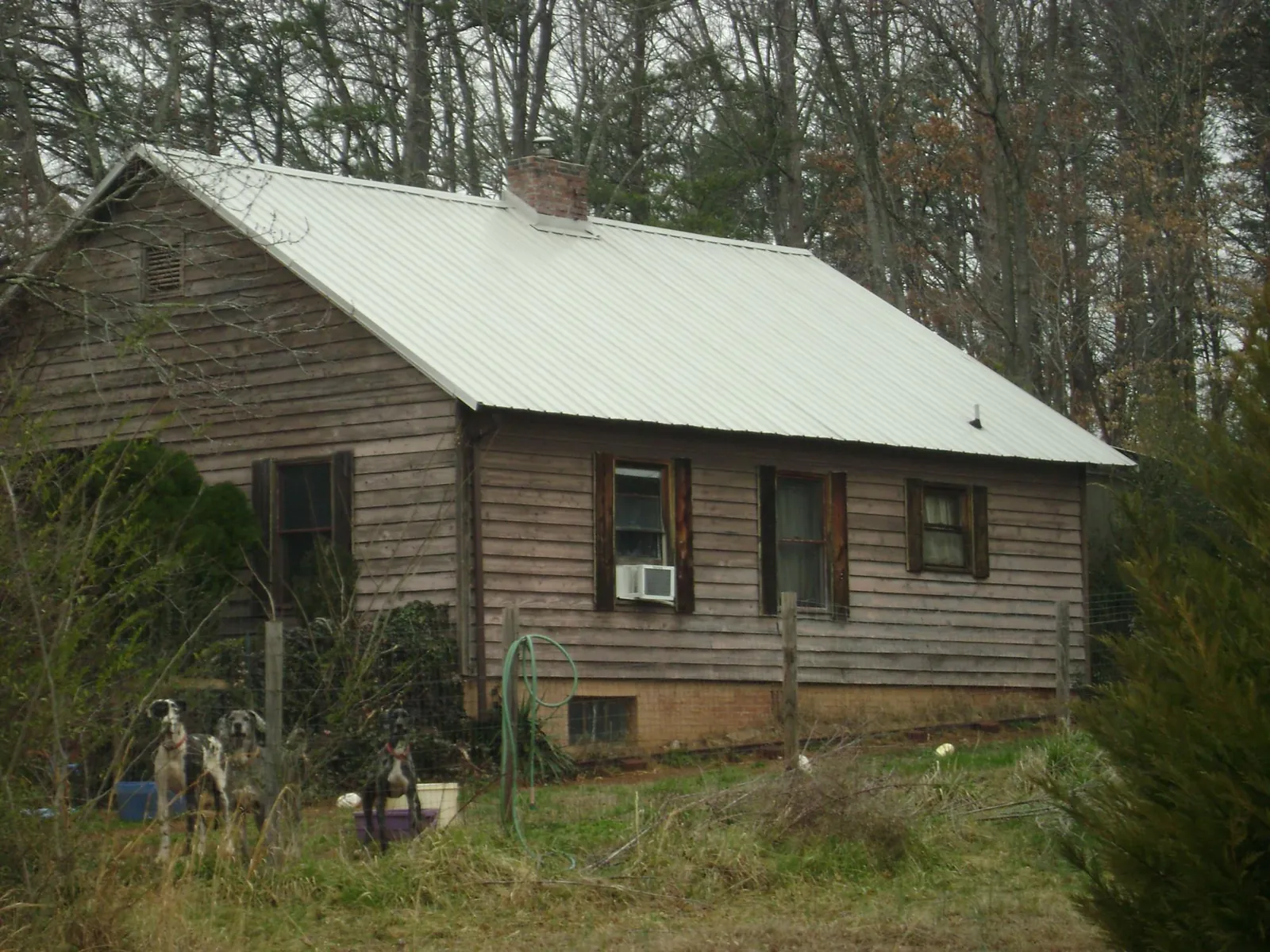 White metal roof on an old wood sided farmhouse, from a Metal Roof Installation job in Crab Orchard